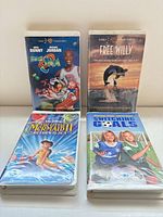 Front view of four VHS tapes showing titles and cover art
