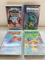 Front view of four VHS tapes in clamshell cases