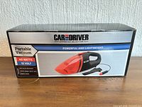 Front of box showing vacuum image, wattage, voltage