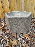 Front view showing exposed-aggregate peagravel exterior and hexagonal form