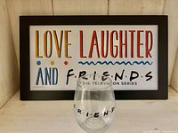 Front view of framed sign and tumbler