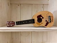 Full ukulele front view on shelf