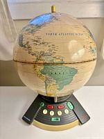 Front view of globe on electronic base showing North Atlantic and control panel
