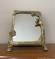 Front view of brass framed mirror showing overall design