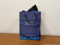 Blue paper carry bag front view