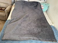 Weighted blanket spread on bed full view