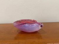 Side profile of pink sommerso glass bowl showing layered colors and lip detail
