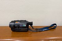 Left side profile of Sony Handycam Vision CCD-TRV25 camcorder showing branding and strap