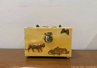 Front view showing animal decals, clasp, feet