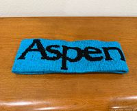 Front view of turquoise knit headband showing Aspen text
