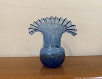 Front view showing ruffled fan rim and crackle texture