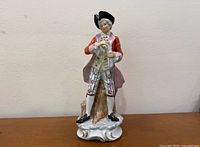 Front view of porcelain colonial man figurine