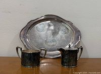 Full view of silverplate platter, sugar bowl, and creamer