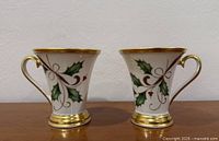 Front view of both Lenox Holiday Nouveau mugs showing pattern and gold trim