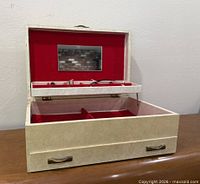 Jewelry box open showing mirror, tray, drawer handle