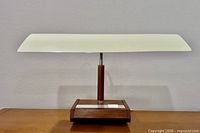 Front view of lamp showing full width shade and wooden base