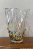 Front view of vase showing confetti pattern and ruffled rim