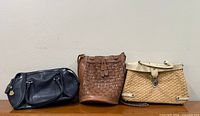 All three handbags displayed front view