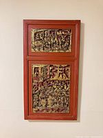 Front view showing entire two-panel carved and gilded wall relief