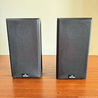 Pair of speakers with grilles attached, front view