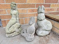 Front view of all three statues showing size comparison and overall condition