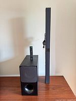 Soundbar, subwoofer, remote, power cable visible side by side