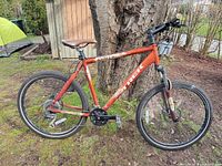 Full side view of orange Trek hybrid bicycle