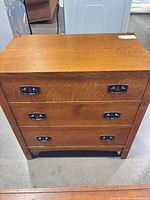 Front view of Mission style oak chest showing three drawers and hardware