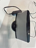 Front angled view showing full speaker, dock, and power adapter