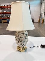 Complete lamp with shade and cord visible