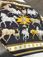 Full view of Hermès Les Chevaux Qataris silk scarf showing horse print and border