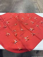 Scarf laid flat showing persimmon ground and floral pattern