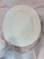 Overview of entire white oval platter on packing paper