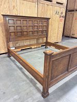 Full view of assembled king bed frame showing headboard, side rails, footboard