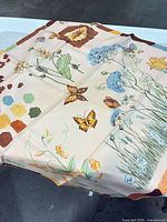 Full laid-out scarf showing overall floral, butterfly and color-swatch design