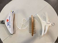 Group shot of assorted hangers, anchor hook, promotional inserts and rectangular wood tie rack