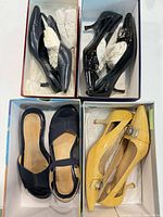 Overview of all four shoe pairs in boxes