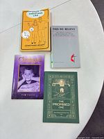 All four paperback books laid out on table