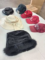 All seven hats arranged on table