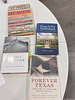All four hardcover books displayed on table