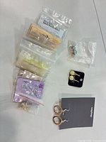 Group shot of all earring pairs and bags of findings laid out