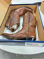 Pair of Lucchese cowboy boots inside original box