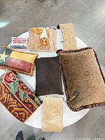 Top view of eight decorative pillows displaying various patterns and textures on a round surface