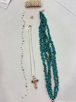 All five jewelry pieces laid out