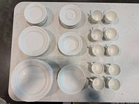 Top view of entire dinnerware set showing plates, bowls, cups