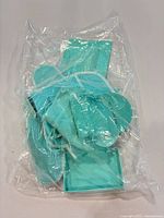 Clear plastic bag containing multiple Tiffany Blue velvet pouches and one small jewelry box