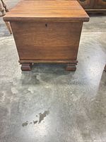 Front view of solid wood blanket chest on bracket feet