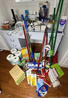 Overview of lot with cleaning tools, toilet paper, boxes and LED bulbs