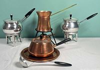 Group view showing copper fondue set, Turkish coffee set and two aluminum warmers