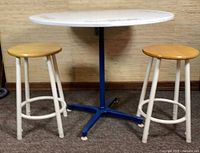 Table and two stools full view showing colors, materials and relative sizes